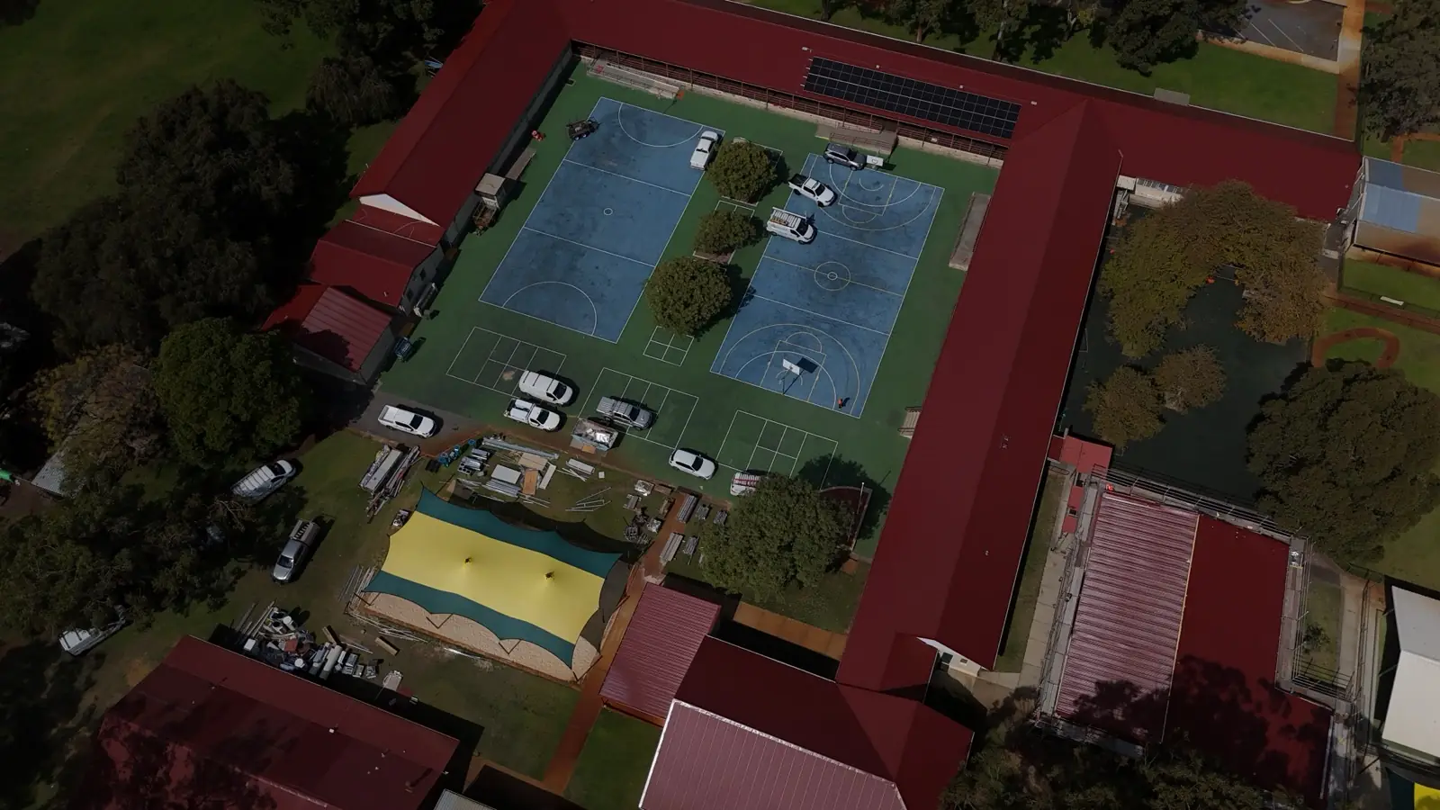 Aerial view of a large commercial roof and grounds in Perth