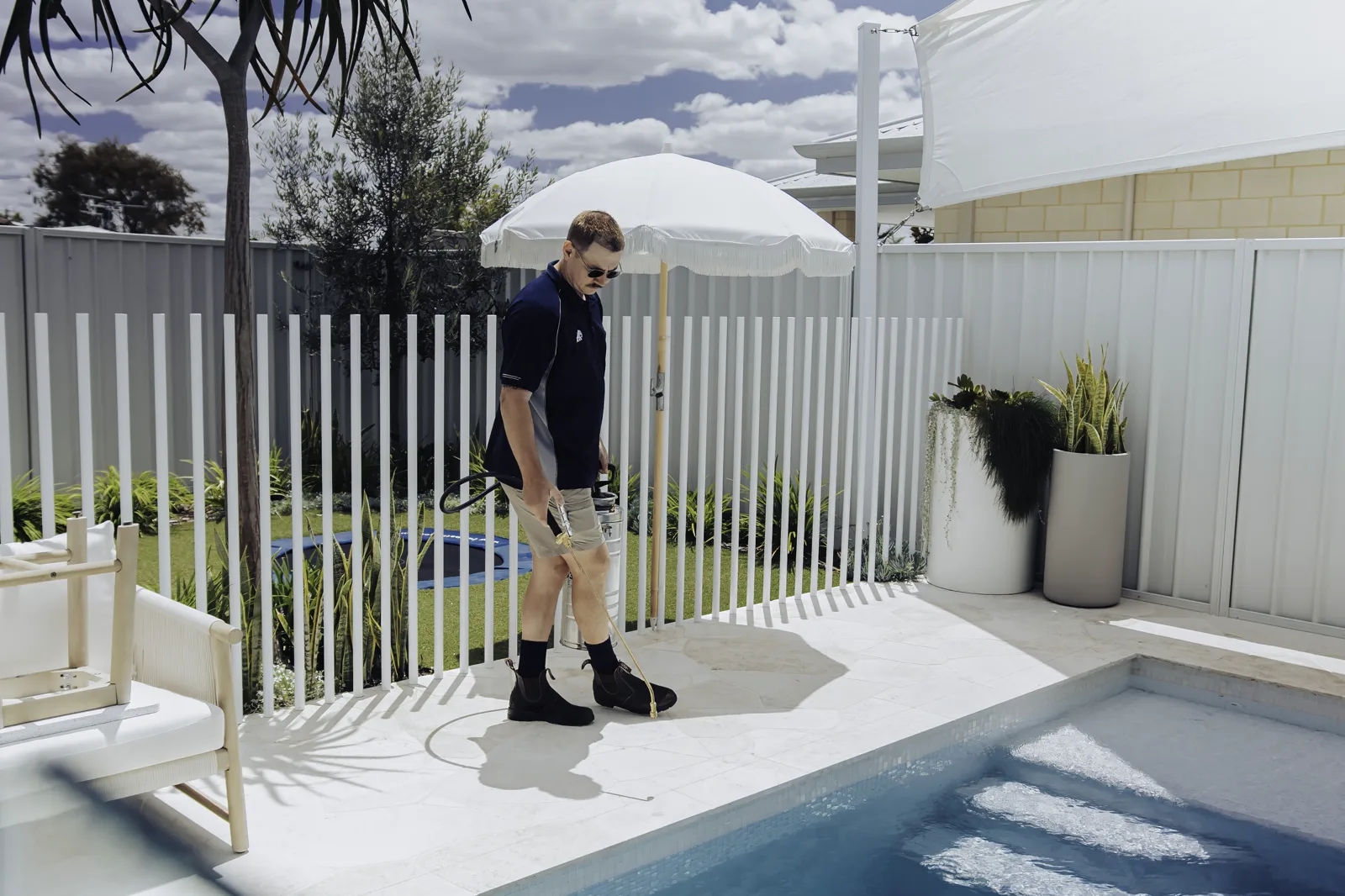 An Extera certified applicator sealing poolside stone in Perth