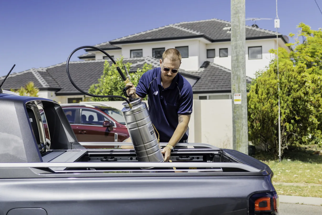 Sealer being applied evenly across a surface, the even coverage a DIY job struggles with on a large area
