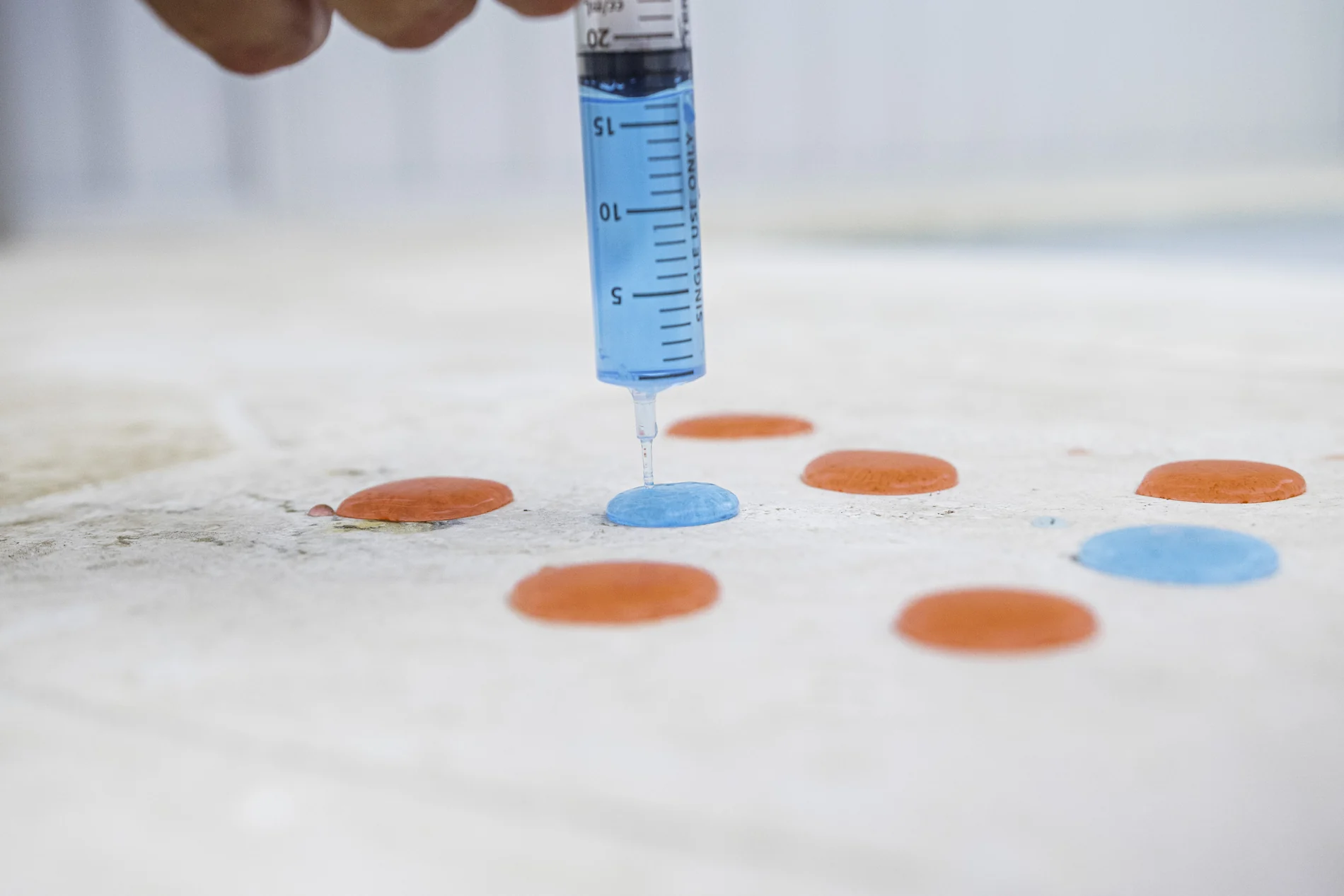 Water beading tightly on a sealed glass surface, ready to roll off and carry its minerals away with far less left behind to dry into scale